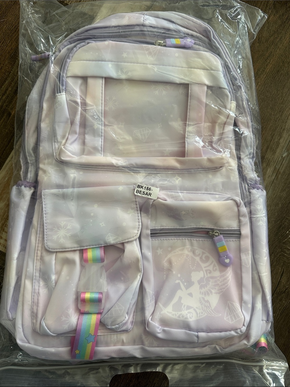 Pink and purple backpack with tinkle bell on the moon.